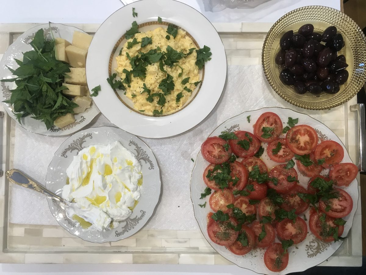 A new traditional breakfast with scrambled eggs, tomatoes, and cheese.