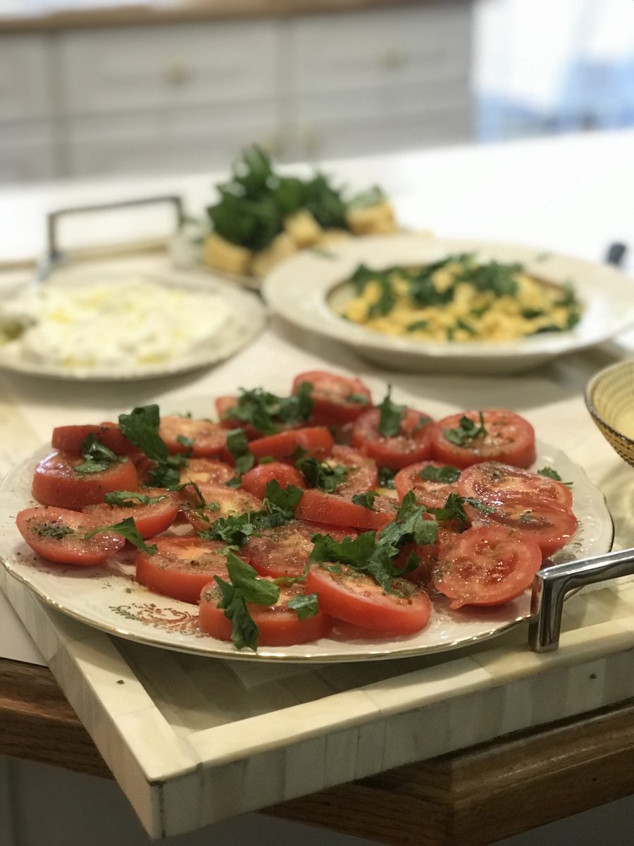 A new traditional breakfast with eggs, tomatoes, cheese, labneh, and olives.
