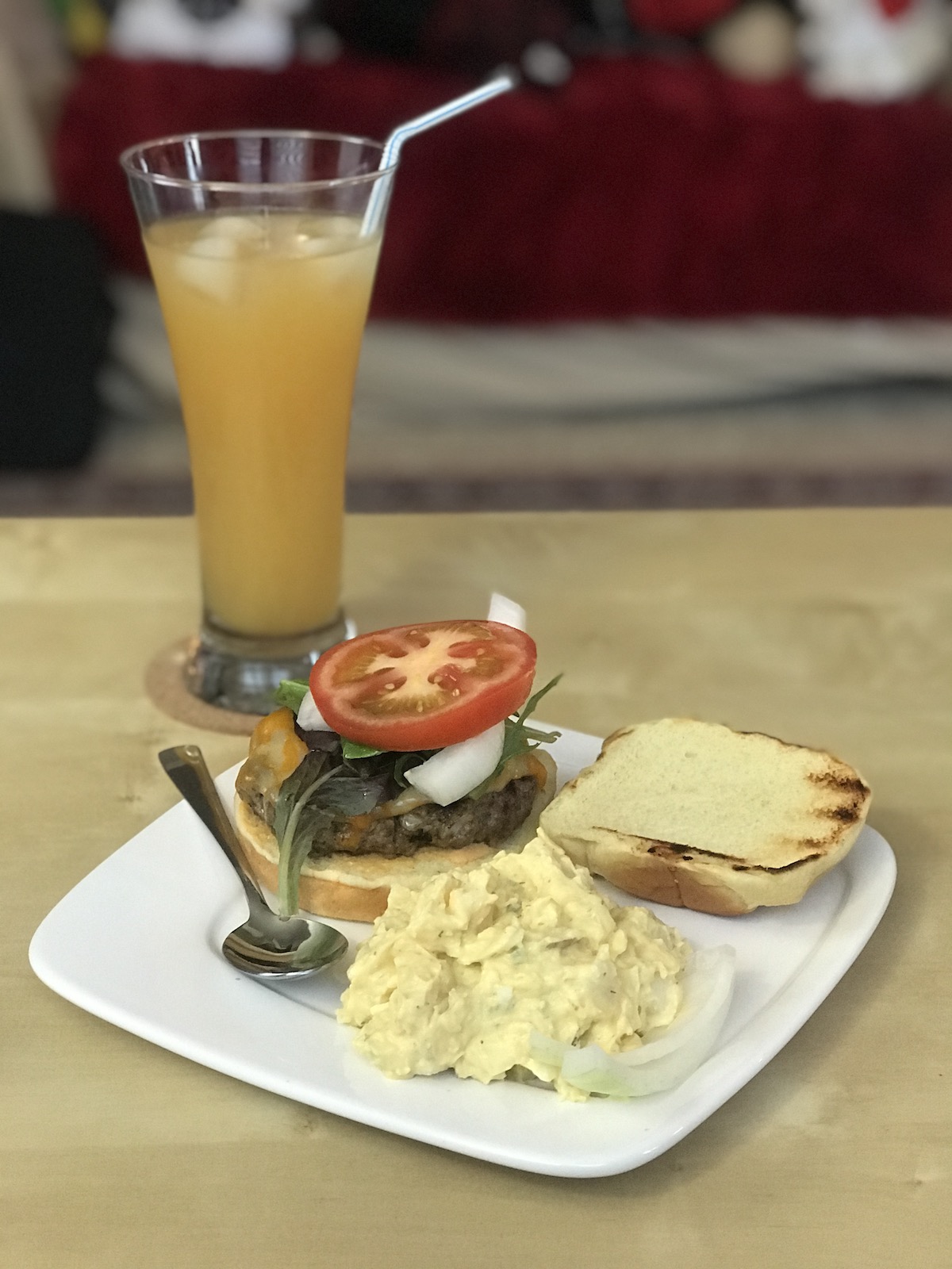 Homemade cheeseburger with potato salad.